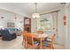 Cozy dining area adjacent to living room, featuring tile floors and natural light at 1354 Lucaya Ave, Venice, FL 34285