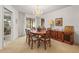 Open dining area with a chandelier and natural light from the backyard at 1354 Lucaya Ave, Venice, FL 34285