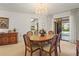 Dining area with a wood table adjacent to sliding glass doors to the pool at 1354 Lucaya Ave, Venice, FL 34285