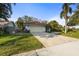 Beautiful single-story home with a well-manicured lawn, tile roof, and spacious driveway at 1354 Lucaya Ave, Venice, FL 34285