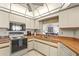 Well-lit kitchen features white cabinetry and a stainless steel sink at 1354 Lucaya Ave, Venice, FL 34285