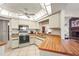 Kitchen area featuring white cabinets, wood countertops, appliances, and an opening into the living room area at 1354 Lucaya Ave, Venice, FL 34285