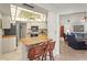 Bright kitchen area with a breakfast bar that provides seating for two, white cabinets, and access to the living room at 1354 Lucaya Ave, Venice, FL 34285