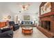 Cozy living room with tile floors, brick fireplace, and comfortable seating at 1354 Lucaya Ave, Venice, FL 34285