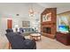 Bright living room with a brick fireplace, tile floors, and comfortable furnishings at 1354 Lucaya Ave, Venice, FL 34285