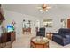 Inviting living room with tile flooring, ceiling fan and comfortable seating at 1354 Lucaya Ave, Venice, FL 34285