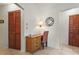 Compact office space with a desk, chair, and storage, illuminated by a wall lamp at 1354 Lucaya Ave, Venice, FL 34285