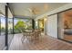 Cozy covered patio with a ceiling fan and an outdoor dining set, offering a tranquil space at 1354 Lucaya Ave, Venice, FL 34285