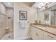 Well-lit bathroom with a walk-in shower, granite counters, and white cabinets at 137 Avenida Messina # 3, Sarasota, FL 34242