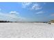 Expansive view of Siesta Key beach, featuring white sands and a vast blue sky with scattered clouds at 137 Avenida Messina # 3, Sarasota, FL 34242