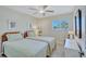 Bright bedroom featuring two twin beds, ceiling fan, and a window with natural light at 137 Avenida Messina # 3, Sarasota, FL 34242