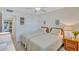 Comfortable bedroom featuring two twin beds, wood flooring, and a view to the entryway at 137 Avenida Messina # 3, Sarasota, FL 34242