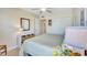 Bright bedroom with twin beds, a closet, and a dresser with decorative baskets at 137 Avenida Messina # 3, Sarasota, FL 34242