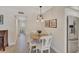 Cozy dining area with wood table, white chairs, and modern lighting at 137 Avenida Messina # 3, Sarasota, FL 34242