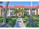 Attractive condo building with a red roof, beautiful palms, and meticulously maintained landscaping at 137 Avenida Messina # 3, Sarasota, FL 34242