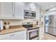 Modern kitchen features stainless steel appliances, white cabinets, and tan countertops at 137 Avenida Messina # 3, Sarasota, FL 34242