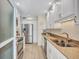 Bright kitchen features white cabinetry, stainless appliances, and stone countertops at 137 Avenida Messina # 3, Sarasota, FL 34242