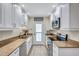 Updated kitchen featuring stainless steel appliances, white cabinets, and granite countertops at 137 Avenida Messina # 3, Sarasota, FL 34242