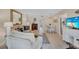 Well-lit living room with comfortable furnishings, dining area, and a view into other rooms at 137 Avenida Messina # 3, Sarasota, FL 34242