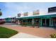 Commercial property featuring retail shops with turquoise awnings for rentals, insurance, and real estate at 137 Avenida Messina # 3, Sarasota, FL 34242