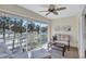 Inviting screened porch with seating, offering views of tropical landscaping and a glimpse of the street at 137 Avenida Messina # 3, Sarasota, FL 34242