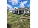 Expansive backyard featuring a covered patio, ideal for outdoor entertaining and relaxation at 1402 Jakway Rd, North Port, FL 34288