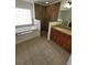 Well-lit bathroom with soaking tub, a walk-in shower, and double vanity at 1402 Jakway Rd, North Port, FL 34288