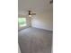 Cozy bedroom with neutral carpet, a ceiling fan, and a bright window at 1402 Jakway Rd, North Port, FL 34288