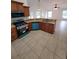 Open kitchen featuring wooden cabinets, granite countertops, and appliances at 1402 Jakway Rd, North Port, FL 34288