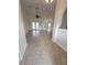 Open living room boasts tile flooring, high ceilings, and access to the outdoor patio at 1402 Jakway Rd, North Port, FL 34288