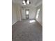 Spacious main bedroom with a ceiling fan and hallway that leads to the bathroom at 1402 Jakway Rd, North Port, FL 34288