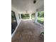 Covered patio featuring decorative concrete, ceiling fan, and ample space for outdoor seating at 1402 Jakway Rd, North Port, FL 34288