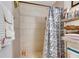 This bathroom has a tiled shower with a curtain and a shelf for toiletries at 1410 24Th E Ave, Bradenton, FL 34208