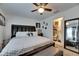 Bright bedroom with ensuite bathroom, features a ceiling fan and patterned bedding at 1410 24Th E Ave, Bradenton, FL 34208