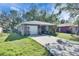 Single-Gathering home with a front yard, concrete driveway, and attached garage at 1410 24Th E Ave, Bradenton, FL 34208