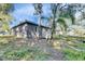 Side view of the house showcasing its neutral stucco finish and a lush green yard at 1410 24Th E Ave, Bradenton, FL 34208