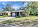Well-maintained home with a front lawn, landscaping, and an attached garage at 1410 24Th E Ave, Bradenton, FL 34208