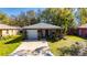 Inviting single-story home featuring a large driveway, a one car garage, and a cozy front yard with mature landscaping at 1410 24Th E Ave, Bradenton, FL 34208