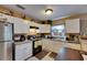 Bright kitchen with white cabinets, stainless steel refrigerator, and breakfast bar at 1410 24Th E Ave, Bradenton, FL 34208
