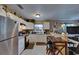 Bright kitchen with white cabinets, stainless steel refrigerator, breakfast bar with seating at 1410 24Th E Ave, Bradenton, FL 34208