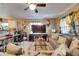 Well-lit living room featuring a ceiling fan and decorative wall art, creating a cozy and inviting atmosphere at 1410 24Th E Ave, Bradenton, FL 34208