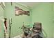 A compact home office featuring bright green walls and unique wall art with a dedicated workspace and modern black chair at 1410 24Th E Ave, Bradenton, FL 34208
