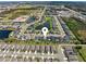 Aerial view of the community showcasing a beautiful pond, lush landscaping, and well-maintained homes at 14355 59Th E Cir, Bradenton, FL 34211