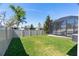 Well-maintained backyard with lush green grass and a screened-in lanai, perfect for outdoor activities at 14355 59Th E Cir, Bradenton, FL 34211