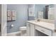 This bathroom features a vanity with white cabinets and a shower with light blue walls at 14355 59Th E Cir, Bradenton, FL 34211