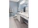 Bathroom boasts a well-lit vanity with grey flooring and a combo shower and tub at 14355 59Th E Cir, Bradenton, FL 34211