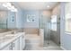 Stylish bathroom featuring a soaking tub, glass-enclosed shower, and modern fixtures for a spa-like experience at 14355 59Th E Cir, Bradenton, FL 34211