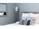 Serene bedroom featuring a comfortable bed with decorative pillows, a modern lamp, and a stylish mirror at 14355 59Th E Cir, Bradenton, FL 34211