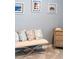 Cozy bedroom nook with a stylish bench, decorative pillows, and a side table for a relaxing atmosphere at 14355 59Th E Cir, Bradenton, FL 34211