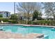 Inviting community pool with clear blue water, sun loungers, and lush landscaping for relaxation and enjoyment at 14355 59Th E Cir, Bradenton, FL 34211